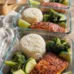 20-minute high protein lunch meal prep with salmon, rice, and roasted broccoli in a glass container