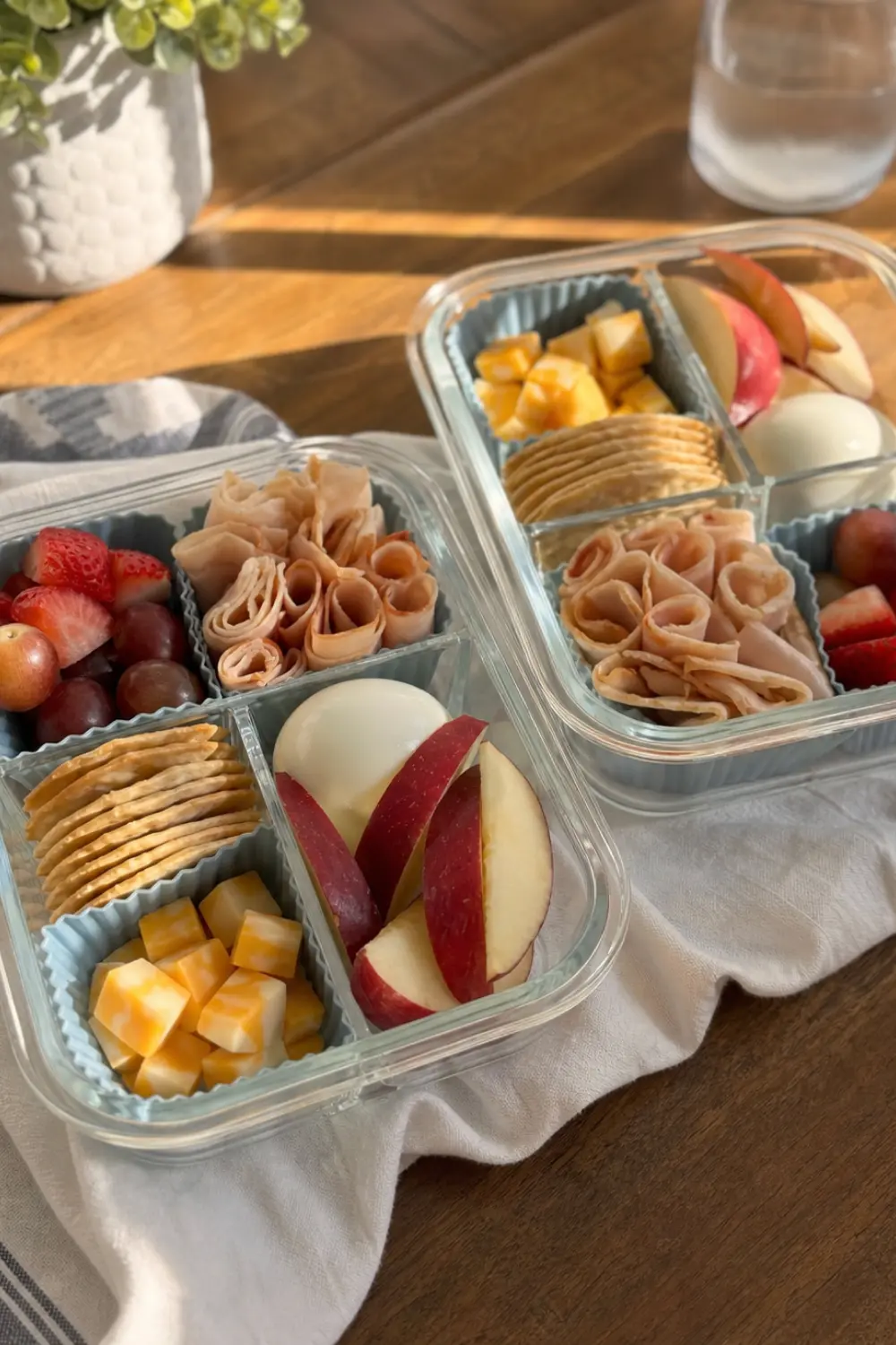 Adult lunchable bento box meal prep with protein, cheese, crackers, and fresh veggies