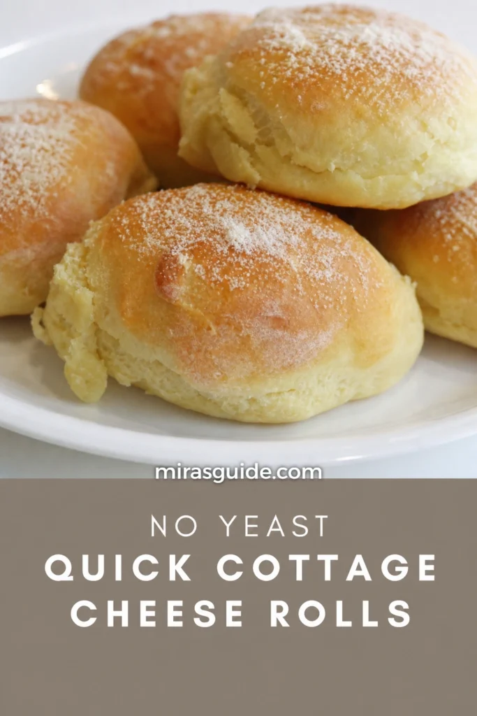 No-yeast quick cottage cheese rolls, golden and dusted with flour, on a white plate