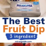 Creamy fruit dip with strawberry dipped, fresh berries around